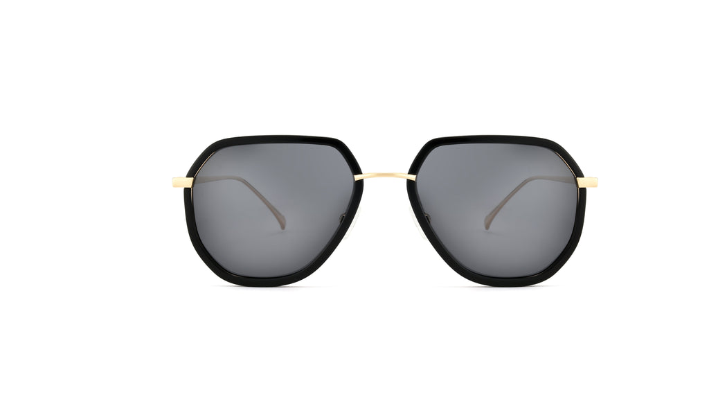 A pair of geometric sunglasses with a black frame, dark gray lenses, and gold metal bridge and temple tips, shown against a plain white background.