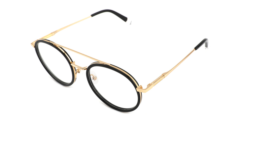 Oversized oval eyeglasses featuring a double bridge design with gold-tone metal and black acetate rims, set against a plain white background.