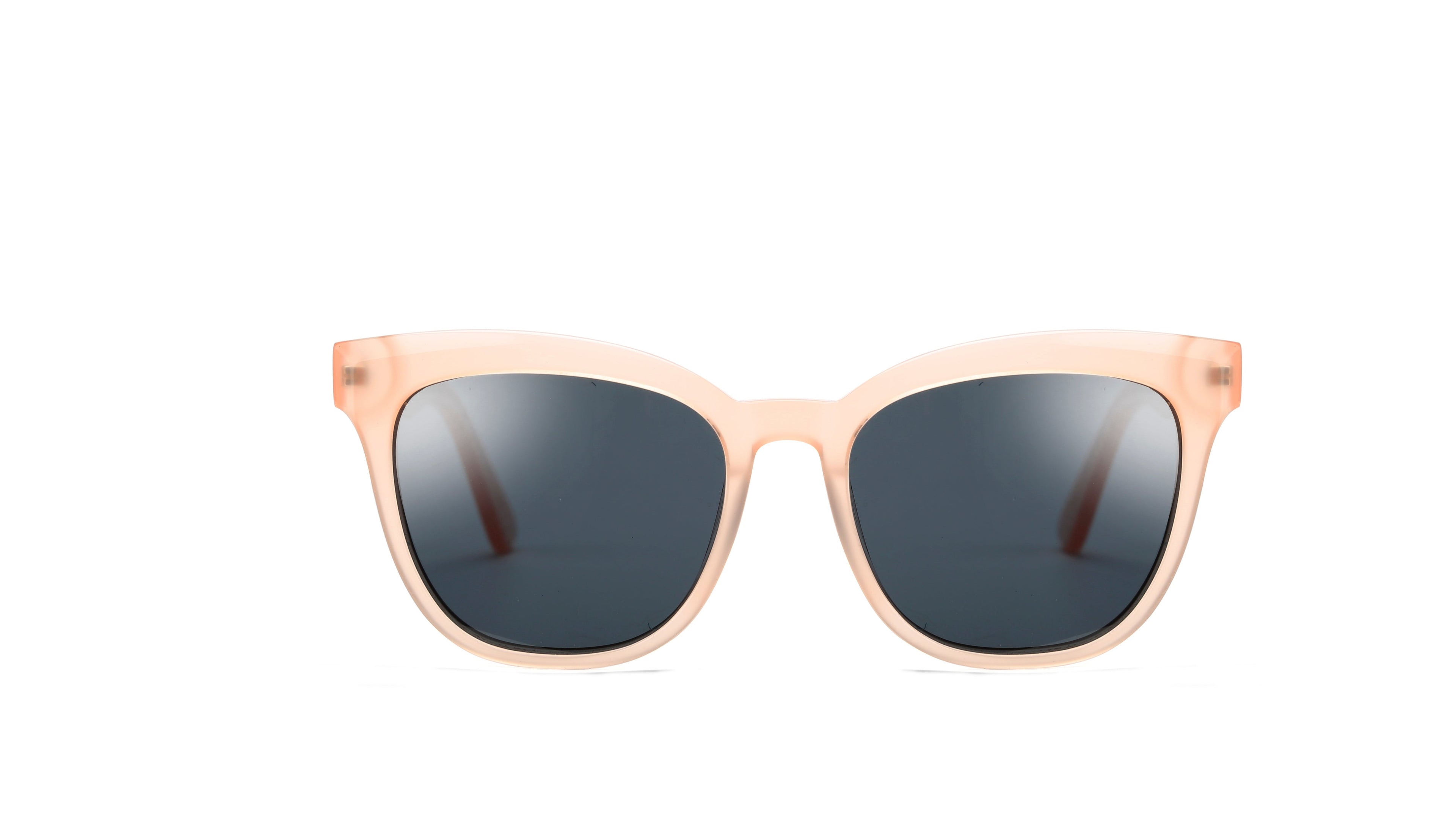 A pair of cat-eye sunglasses with a translucent peach-pink frame and dark gray lenses, shown against a plain white background.